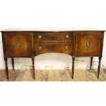 A reproduction mahogany serpentine side board, with two drawers and two cupboard doors,