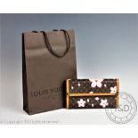 A Louis Vuitton Limited Edition Cherry Blossom Porte Tresor international wallet with gold coloured