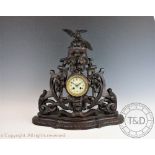 A large carved Black Forest mantel clock,