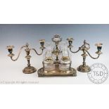 A 19th century silver plated decanter stand, with three cut glass decanters and stoppers, 28cm high,