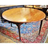 A George III mahogany drop leaf dining table, on tapered legs and pad feet,