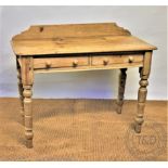 A pine wash stand, with two drawers, on turned legs,