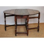 An 18th century oak gate leg table, with drawer, on turned and block legs,