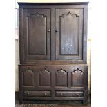 An 18th century oak livery cupboard, with two panelled doors,