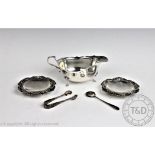 A George VI silver sauce boat, Sheffield 1948, with a pair of embossed silver dishes,