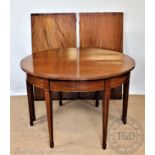 An inlaid mahogany 'D' end dining table, with two spare leaves, on tapered legs, 76.