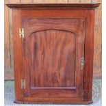 A George III style mahogany bow front hanging corner cabinet,