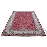 A Kashmir tree of life carpet, worked with a tree, animals and flowers against a red ground,