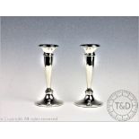 A pair of silver candlesticks, Napper and Davenport, Birmingham 1919,