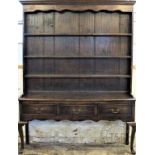 A George III style high back oak dresser, with three tier plate rack on base with three drawers,