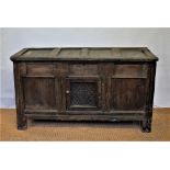 An 18th century and later oak coffer, with panelled top and front,