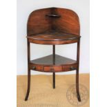 A mahogany three tier hanging shelf, with serpentine sides, 75cm H x 95cm W,