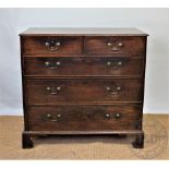 A George III oak chest, of two short and three long drawers, on bracket feet,