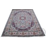 A Kashmir carpet, worked with a traditional floral design against a duck egg blue ground,