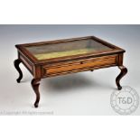 An Edwardian table top walnut bijouterie table, with moulded detailing, on cabriole legs,