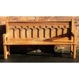 A 19th century style golden oak settle, the back carved with ten arches, on chamfered legs,