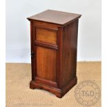 An Edwardian Howard & Sons walnut bedside cupboard, with panelled door, on bracket feet,