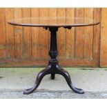 A George III mahogany tilt top occasional table, with circular top, on tripod base,