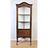 An Edwardian mahogany display cabinet, with astragal glazed door, on tapered legs,