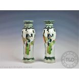 A pair of late 19th century Chinese famille vert vases, of fluted form, decorated with figures,