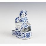A Delft stand in the form of a seated woman, 19th century, probably a pipe rack,