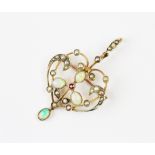 A Victorian seed pearl and opal sinuous brooch/pendant, of typical openwork design,