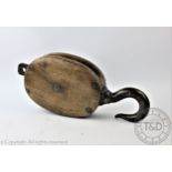 A marine oak and iron hook pulley, 47cm, with a Victorian carved ivory box and cover,