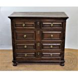 An 18th century and later oak chest, with two short and three long drawers with fielded fronts,