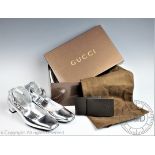 A pair of silver Gucci shoes with rounded square toe,