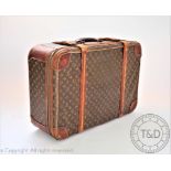 A Vintage Louis Vuitton suitcase with soft leather top and two strap closure, H 49cm x W 70cm,
