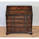 A reproduction mahogany bureau, with fall enclosing a fitted interior,