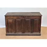 An 18th century oak coffer, with arched panelled front, on plinth base,