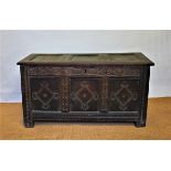 An 18th century oak coffer, with later carved detailing on stile feet,