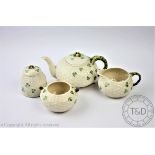 A Belleek four piece part tea service, comprising teapot and cover, sugar bowl,