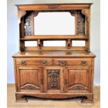 An Arts and Crafts carved golden oak high back dresser,