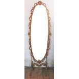 A gilt brass oval cheval mirror,