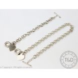 A Tiffany and Co silver toggle necklace and matching bracelet, each with heart shaped tag,