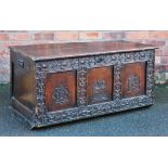 An 18th century and later oak coffer, with carved detailing and key,