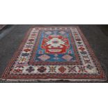 A Turkish wool carpet, worked with geometric motifs,