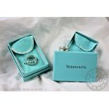 Two Tiffany & Co silver rings, to include a rounded square example and a concave example,