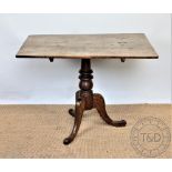 A George III and later oak table, with rectangular top, on turned column and tripod base,