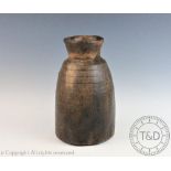A Tribal hard wood vase, possibly West African, of hollowed cylindrical form with fared neck,