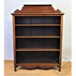 An Edwardian mahogany open bookcase, with adjustable shelves,