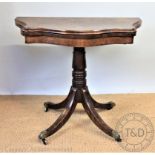 A Victorian walnut serpentine card table, with turned column and splayed legs,