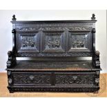 A Victorian carved oak settle,