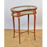 An Edwardian inlaid satinwood kidney shaped bijouterie table in the manner of Edwards and Roberts,