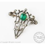 A Victorian emerald and diamond brooch, the sinuous,