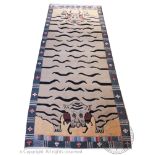 An Alain Rouveure Tibetan wool tiger carpet, worked with two tigers heads within a striped border,