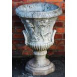 A reconstituted stone garden planter, modelled as a twin handled urn,