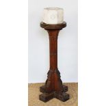 An ecclesiastical oak font, with reconstituted stone top,